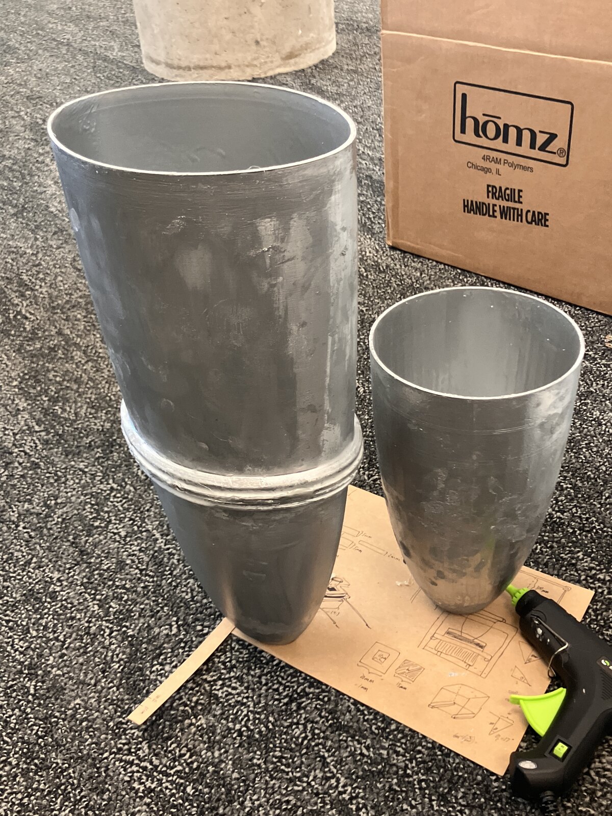 The two finished metallic-coated concentrators standing on a board
