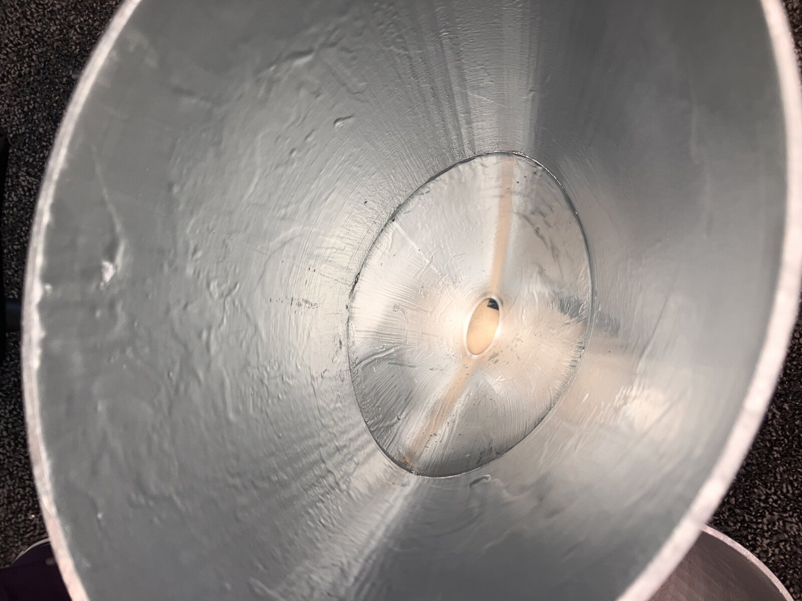 Looking down the inside of a coated concentrator toward the absorber at its base